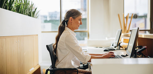 Businesswoman working at office desk