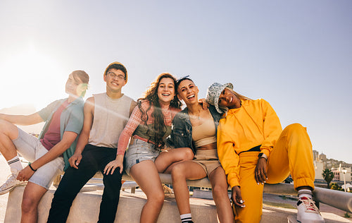 Diverse group of friends sitting together outdoors