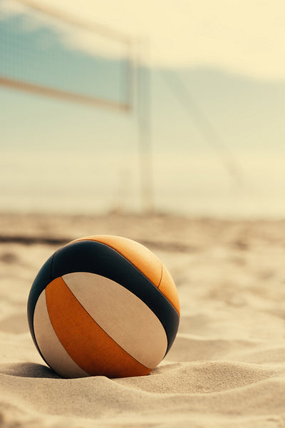 Coastal volleyball game on seaside sand court with ocean view, still life of ball on beach