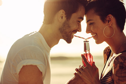 Romantic couple sharing a drink