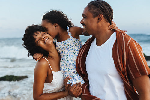 Happy family enjoying a loving beach vacation together