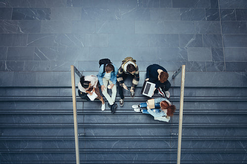 Students studying on stairs at college