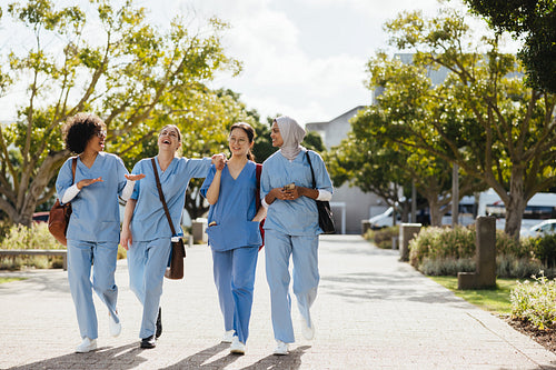 Fun in med school: Female health students laugh together as they walk to class