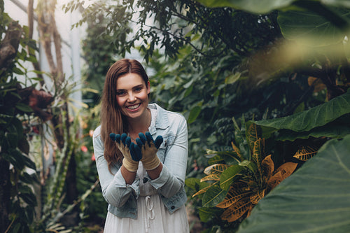 Smiling female gardener in the garden center