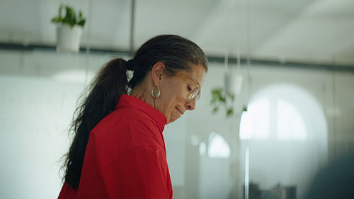 Woman presents during a business meeting in a bright office