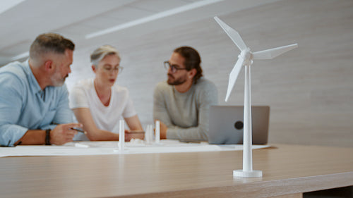 Innovative business team using 3D modeling to design a wind turbine for a sustainable energy project