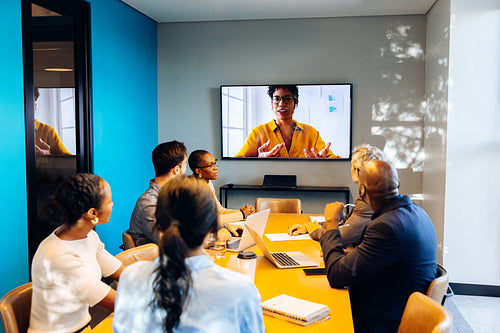 Team engaging in a video conference call inside a professional office setting