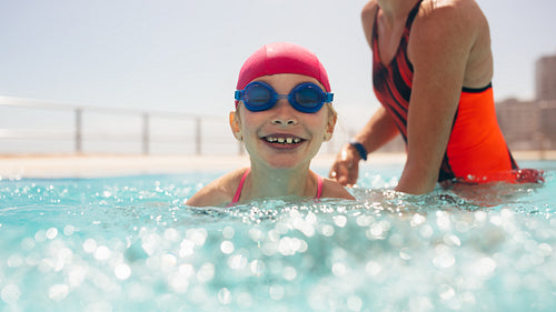 Girl getting swimming lesson in the pool