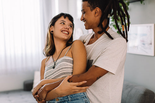 Flirtatious young couple being romantic indoors