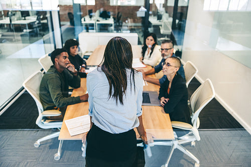 Confident businesswoman leading a meeting in a boardroom
