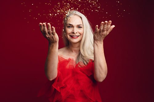 Mature woman having fun with glitters