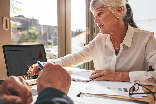 Businesswoman preparing on some financial reports at cafe