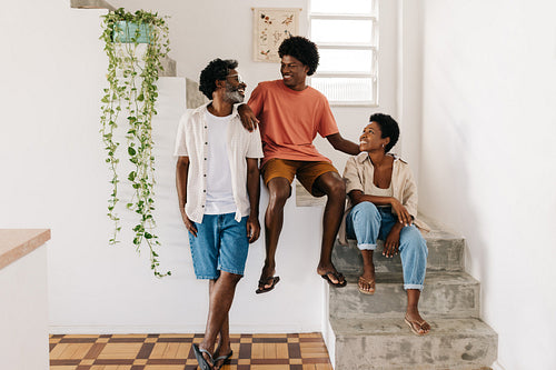 Teenage boy spending quality time with his mature parents in their home