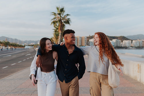 Outdoorsy friends taking a stroll along the waterfront