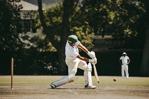 Batter stepping forward to meet the ball