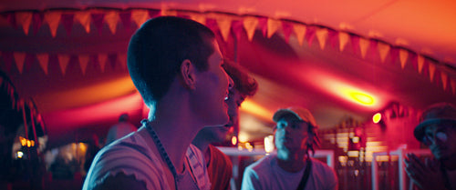 Vibrant group of young friends taking a selfie at a festival