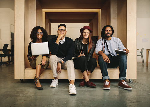 Business colleagues sitting in office in an enclosure