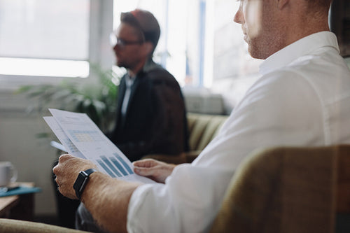 Businessman reading charts during meeting