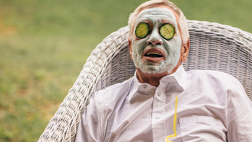 Senior man taking facial spa treatment
