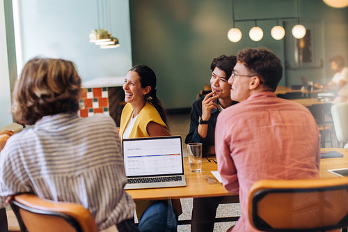 Group discussing project ideas during a casual meeting in a creative workspace