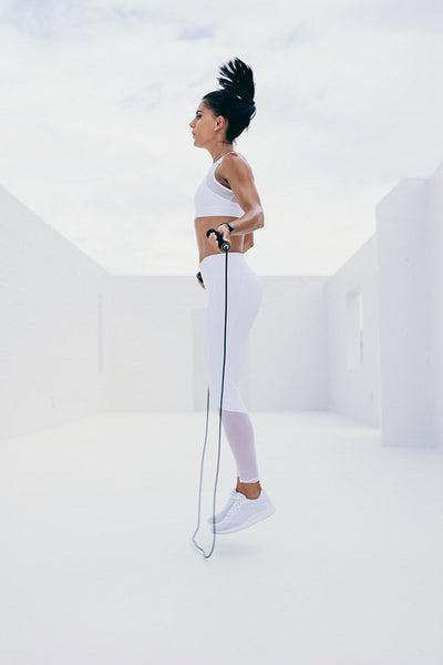 Woman doing fitness training using a skipping rope