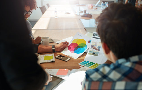 Team brainstorming in meeting room with color swatches