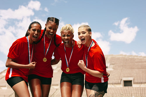 Female football team celebrating the victory
