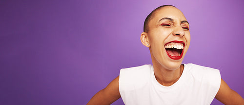 Woman with short hairstyle laughing on purple background