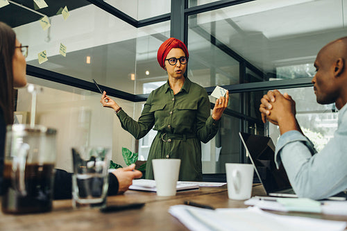 Team leader sharing her creative ideas with her colleagues