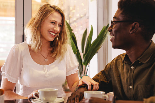Smiling woman meeting her friend at a coffee shop