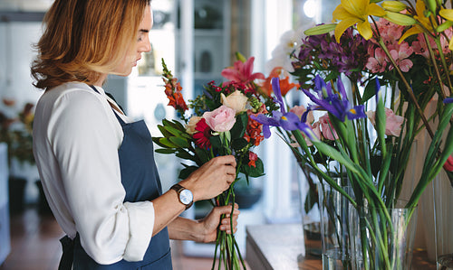 Florist preparing a bouquet with fresh flowers