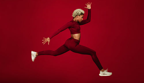 Side view of female athlete running