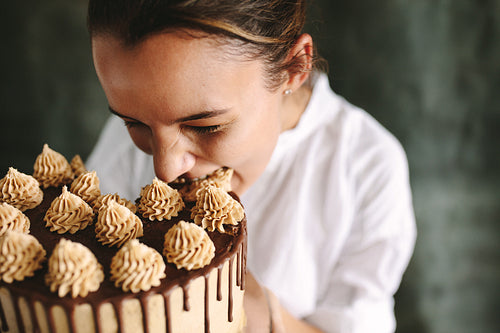 Pastry chef eating whole cake