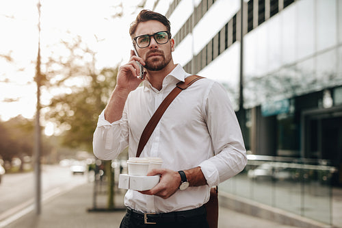 Man talking on cell phone while walking on street