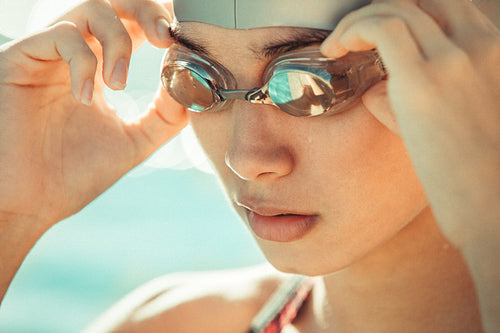 Woman adjusting swim goggles