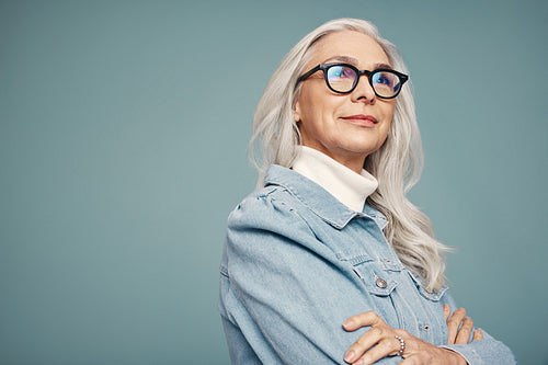 Mature woman looking away thoughtfully in a studio