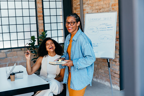Joyful professionals enjoying a successful business meeting on leadership skills in a sleek corporate atmosphere