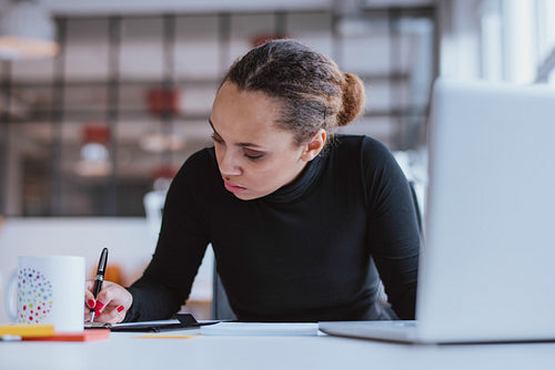 Young woman working at her desk