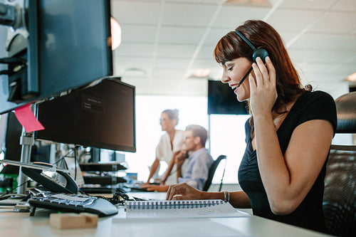 Happy mature business woman talking on headset