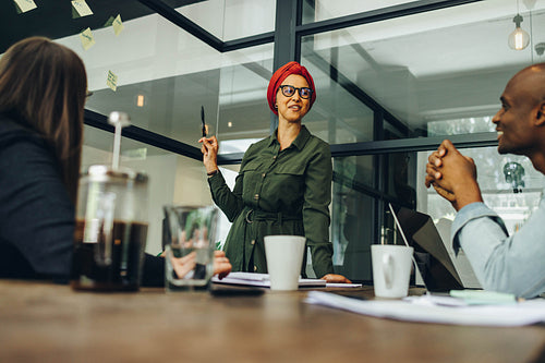 Businesswoman sharing her creative ideas with her colleagues