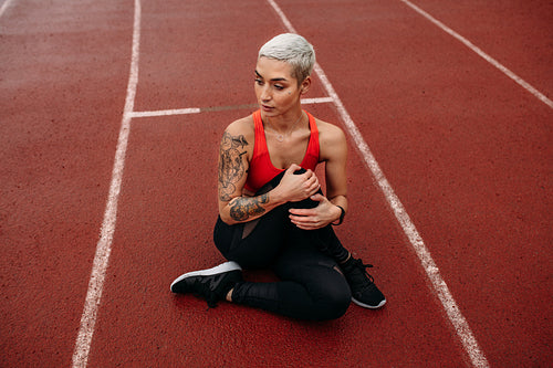 Sprinter sitting on running track