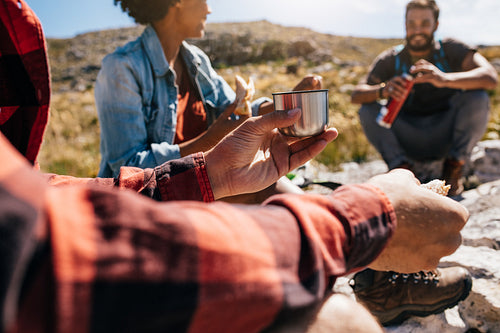Young man relaxing with friends during a hike