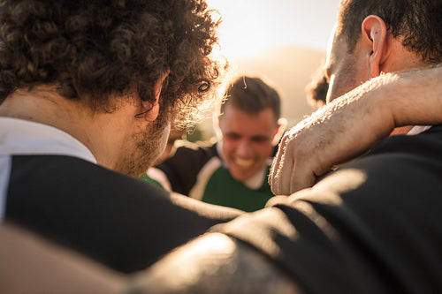 Team of rugby players in a huddle