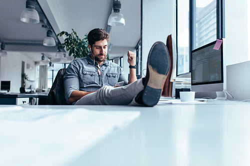 Businessman relaxing in office during break