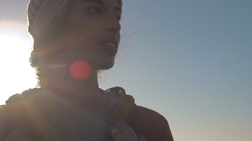 African woman hiker looking around