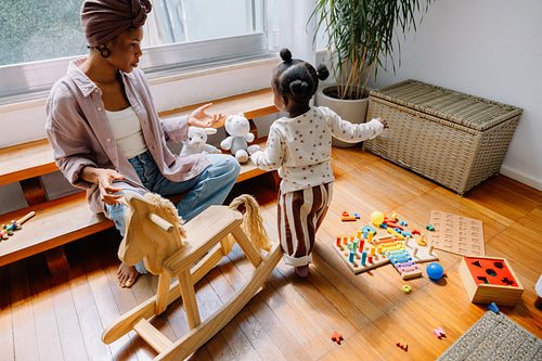 Mother and child playing with toys at home