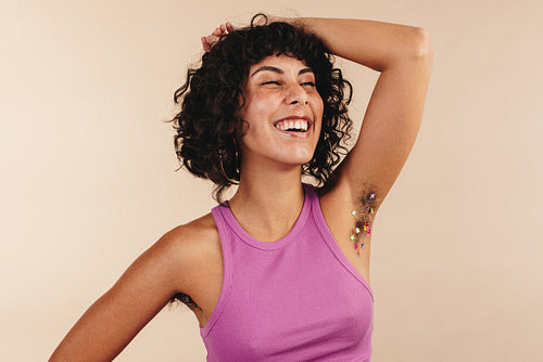 Unshaven young woman laughing cheerfully
