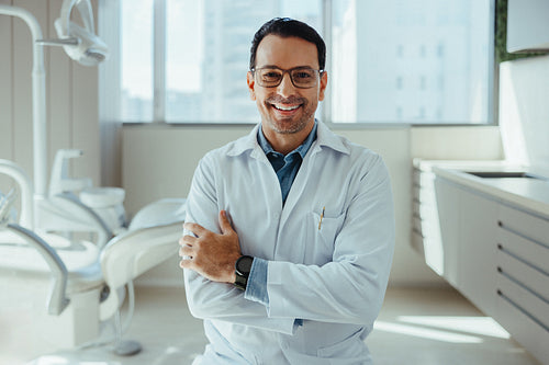 Smiling dentist in a professional office portrait for clinic branding