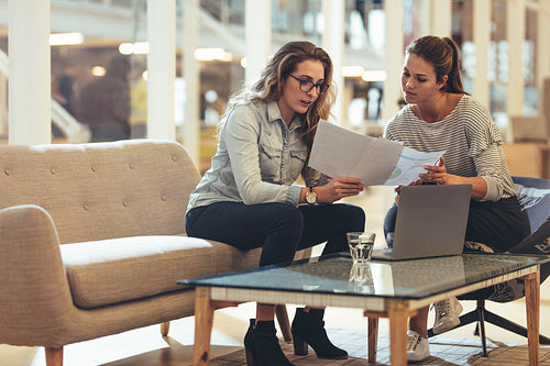 Women entrepreneurs discussing work in office