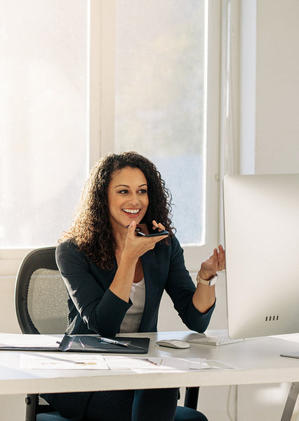 Businesswoman talking on mobile phone in office
